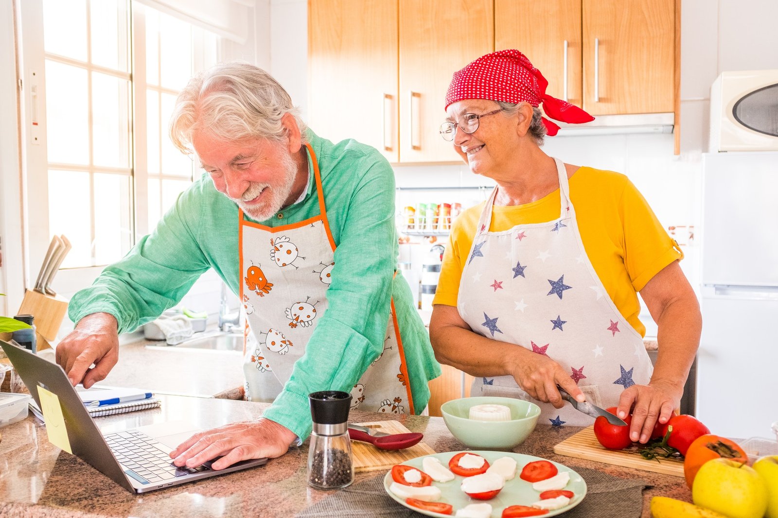 couple-of-two-happy-seniors-cooking-together-in-the-kitchen-learning-and-following-a-video.jpg